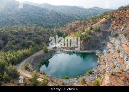 Lake in abandoned pit of basalt quarry near Machairas, Cyprus. Aerial landscape Stock Photo