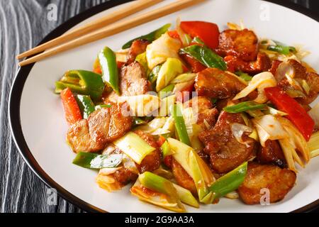 Twice Cooked Pork hui guo rou Szechuan Pork Stir Fry closeup in the plate on the wooden table. Horizontal Stock Photo