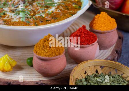 Indian Colourful Spices Also Know as Red Chilli Powder, Turmeric Powder, Coriander Powder, Mirchi, Mirch, Haldi, Dhaniya Powder Isolated on wooden Bac Stock Photo