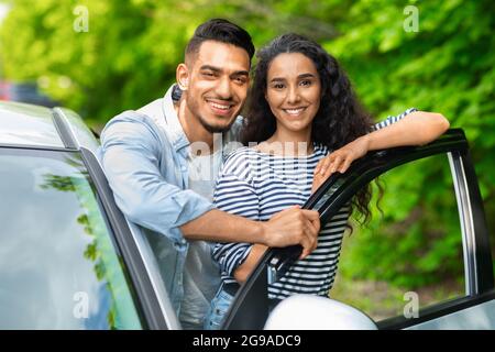 Attractive multiracial lovers enjoying car trip to countryside Stock Photo