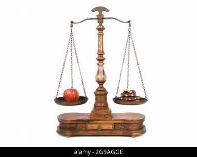 apple and chocolate on a scale as a symbol for healthy and unhealthy food Stock Photo