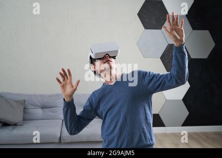 Man is using virtual reality headset. Concept of virtual reality, simulation, gaming and future technology. Stock Photo
