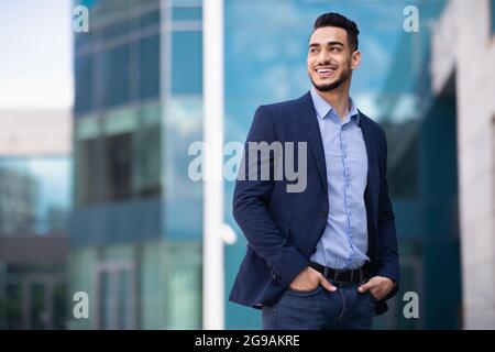 Young arab man standing by business center Stock Photo