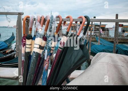 different umbrellas hang side by side on a stand Stock Photo