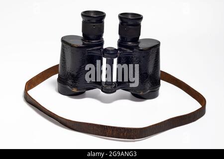 An aged vintage SOVIET MARINE binocular in black body isolated on white background. Stock Photo