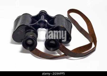 An aged vintage SOVIET MARINE binocular in black body isolated on white background. Stock Photo