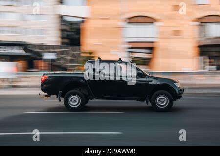 Ukraine, Kyiv - 16 July 2021: Black Mitsubishi L200 car moving on the street. Editorial Stock Photo