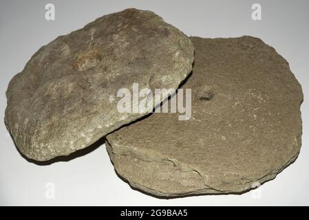 Ancient stone millstones for grinding grain, isolate. Stock Photo