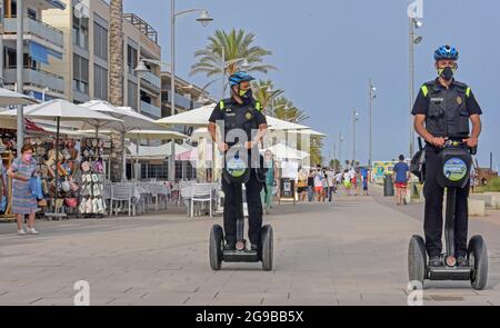 Vendrell, Spain. 23rd July, 2021. Local Police of Vendrell patrol on Sagway electric vehicles. The Local Police of El Vendrell (Spain) incorporates the segway into its vehicle fleets, the one-person transport system that allows greater agility to the police officer and control capacity in pedestrian areas closed to traffic or crowded areas of people and commercial areas. These vehicles reach 20 km/hour, they are electrical equipment, so they do not generate noise or polluting emissions. (Photo by Ramon Costa/SOPA Images/Sipa USA) Credit: Sipa USA/Alamy Live News Stock Photo