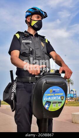 Vendrell, Spain. 23rd July, 2021. A local police officer from Vendrell patrols on an electric segway vehicle. The Local Police of El Vendrell (Spain) incorporates the segway into its vehicle fleets, the one-person transport system that allows greater agility to the police officer and control capacity in pedestrian areas closed to traffic or crowded areas of people and commercial areas. These vehicles reach 20 km/hour, they are electrical equipment, so they do not generate noise or polluting emissions. (Photo by Ramon Costa/SOPA Images/Sipa USA) Credit: Sipa USA/Alamy Live News Stock Photo