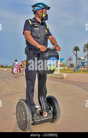 Vendrell, Spain. 23rd July, 2021. A local police officer from Vendrell patrols on an electric segway vehicle. The Local Police of El Vendrell (Spain) incorporates the segway into its vehicle fleets, the one-person transport system that allows greater agility to the police officer and control capacity in pedestrian areas closed to traffic or crowded areas of people and commercial areas. These vehicles reach 20 km/hour, they are electrical equipment, so they do not generate noise or polluting emissions. (Photo by Ramon Costa/SOPA Images/Sipa USA) Credit: Sipa USA/Alamy Live News Stock Photo