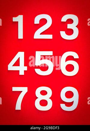 Mathematics background made with solid numbers from 1 to 9 on a red blackboard Stock Photo