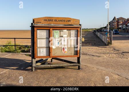West Kirby, Wirral, UK. Community notice board next to the beach, advising of safe route to Hilbre island at low tide. Stock Photo