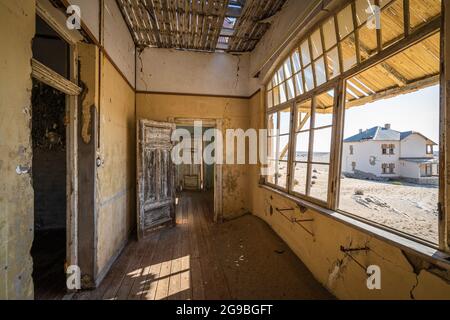 Abandoned building in the old diamond mining town of Kolmanskop near Luderitz, Namib Desert, Namibia. Stock Photo