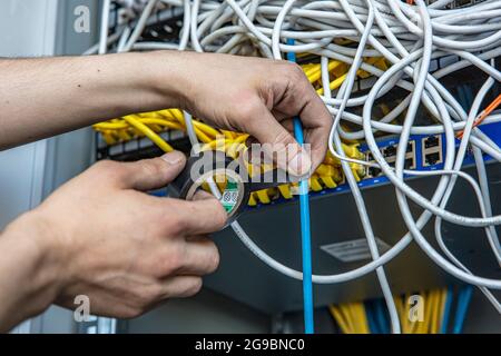 Electrician fixing wires with insulating tape indoors Stock Photo - Alamy