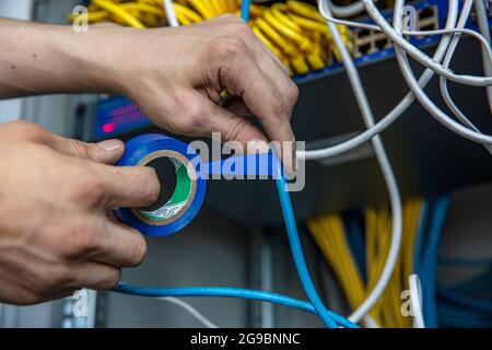 Electrician fixing wires with insulating tape indoors Stock Photo - Alamy