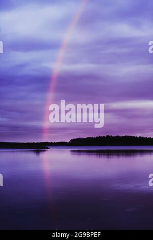Rainbow reflected in water on a lake Stock Photo