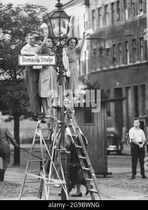 Citizens Of West Berlin Stand On Ladders to Greet Friends and Loved Ones on the Eastern Side of the Berlin Wall, circa 1961 Stock Photo