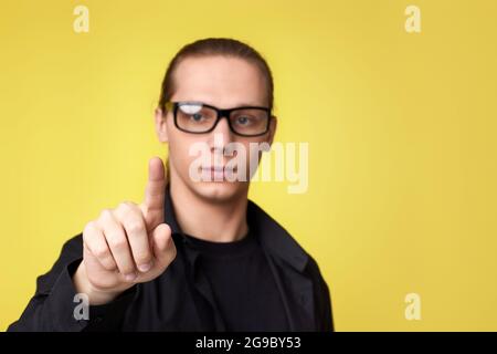 young man in glasses touching virtual screen Stock Photo