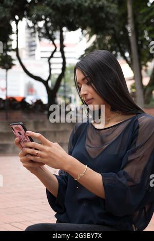 latin woman using a smartphone Stock Photo