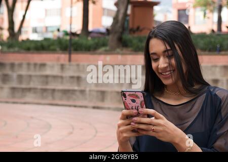 latin woman using a smartphone Stock Photo
