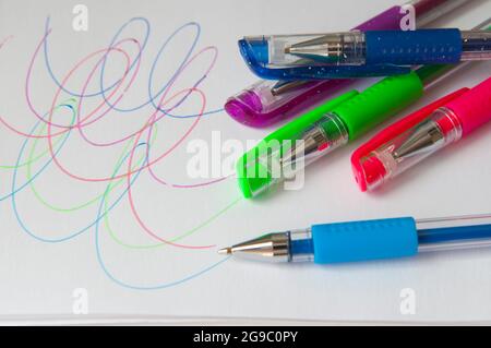 Set of new colorful pens for the school. Drawings on a white paper. Scholar materials Stock Photo
