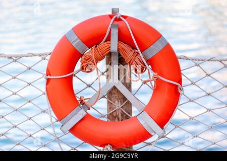 Safeguard ring at the beach. Device helping to float on water. Rescue assistance. Stock Photo