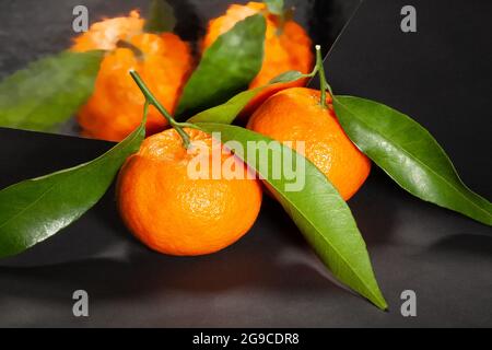 mirrored tangerine on black background Stock Photo