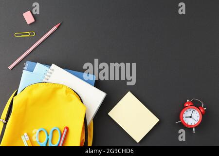 School supplies in a yellow backpack. Stock Photo