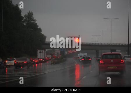Speed Restrictions in place for car drivers driving along roads in heavy rain Stock Photo