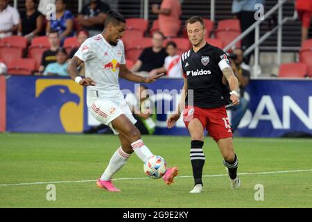 Washington, USA. 02nd Mar, 2020. D.C. United midfielder Frederic Brillant (13) slips a pass past New York Red Bulls forward Fabio Gomes (9) in the first half at Audi Field in Washington, DC, Sunday, July 25, 2021. United defeated the Red Bulls 1-0. (Photo by Chuck Myers/Sipa USA) Credit: Sipa USA/Alamy Live News Stock Photo