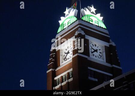 Seattle, United States. 24th July, 2021. The Starbucks logo crests the clock tower at the coffee chain's Seattle headquarters. The company is expected to announce its third quarter earnings on Tuesday. Credit: SOPA Images Limited/Alamy Live News Stock Photo