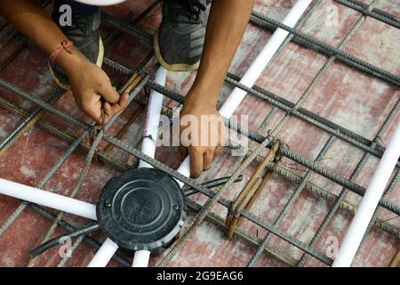 Electric fixture installation during flat construction Stock Photo
