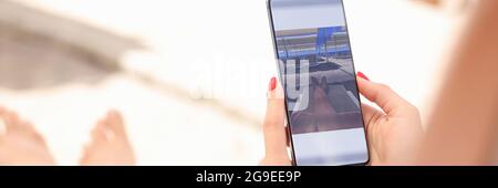 Woman is editing taken photo on smartphone Stock Photo