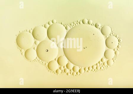 Decorative abstract pattern of a cluster of cream-colored bubbles in assorted sizes in a random arrangement centered in the panel with copyspace Stock Photo