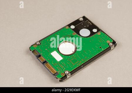 Close-up of the internal hdd of laptop against gray background. Device used to store digital content and other personal data on computers. Computer ha Stock Photo