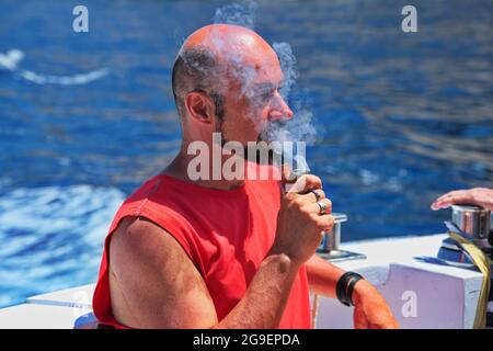 Portrait of a mature man smoking a pipe Stock Photo