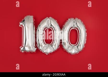Silver foil balloon number digit one hundred. Birthday greeting card with inscription 100 Anniversary celebration event. Banner. Silver numeral wine r Stock Photo