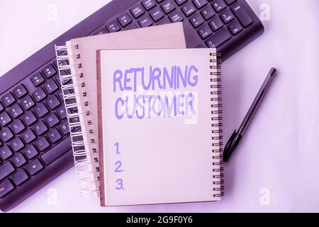 Text sign showing Returning Customer. Business concept customer returns again and again to purchase a good Two Plain Lined Spiral Notebooks With Pen Stock Photo
