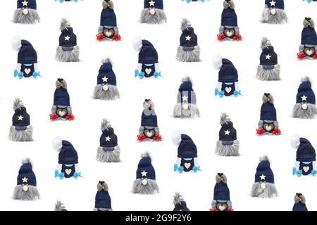Hand made with socks christmas gnomes male with beard and female with plaits on white background pattern Stock Photo