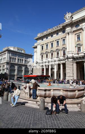 ROME, ITALY - APRIL 10, 2012: People sit by the fountain at Piazza Colonna square in Rome. According to official data Rome was visited by 12.6 million Stock Photo