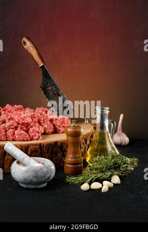 Chopped with butcher cleaver lamb ground meat on wooden stump Stock Photo
