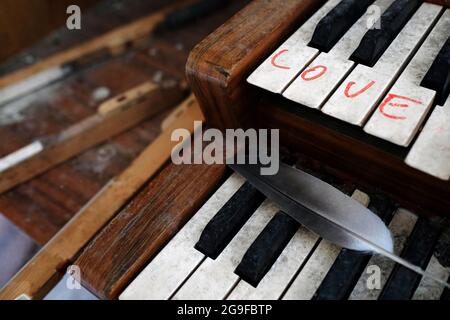 The word "Love" written on an old organ in an abandoned church Stock Photo