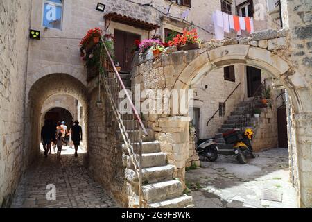 Streets of Trogir old town in Croatia. Narrow quaint alleys in Croatia. Stock Photo