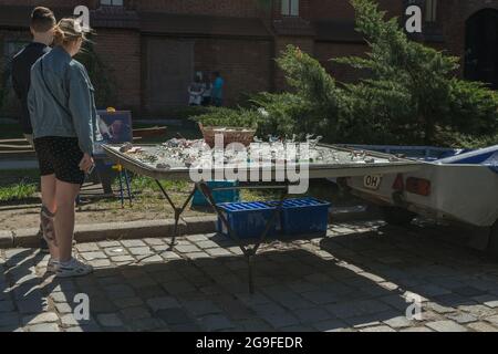 Kaliningrad, Russia - May 10, 2021: people are looking at glass goods made by local famous craftsman Stock Photo