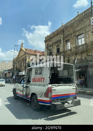 KARACHI, PAKISTAN - Jun 17, 2021: A vertical shot of a security van in Karachi city Saddar roads market Stock Photo