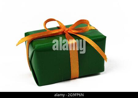 green christmas gift with orange bow isolated on white background Stock Photo