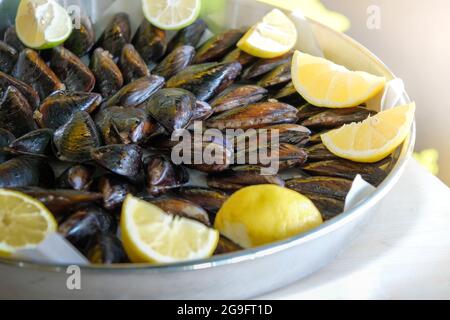 Turkish style street food stuffed mussels midye dolma with lemons Stock Photo