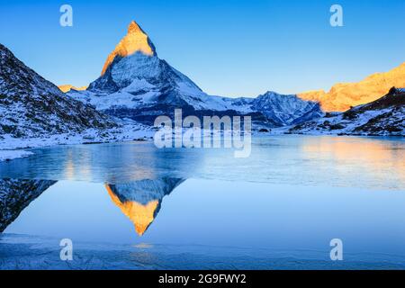 The Matterhorn (4478 m) mirrored in mountain lake (Riffelsee). Zermatt, Valais, Switzerland