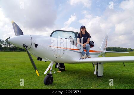 Zara Rutherford alongside a Shark Ultralight aircraft at Popham Airfield in Winchester, Hampshire. The 19 year-old Belgian is attempting to set a new record and become the youngest woman to fly around the world solo in a small plane. Picture date: Monday July 26, 2021. Stock Photo